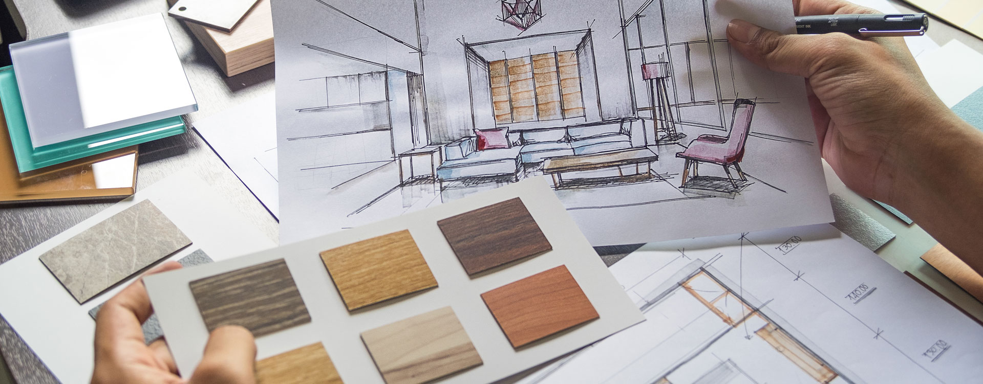 an image of a hand holding a sketch of a room in one hand and some material samples in the other